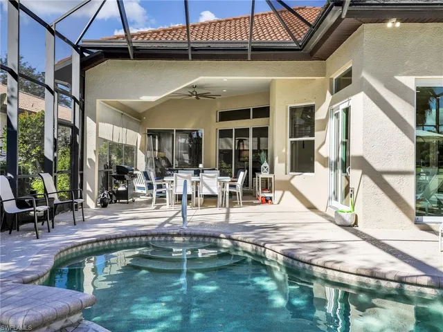 a view of a swimming pool with sitting area