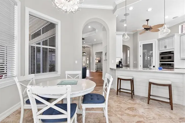 a view of a dining room with furniture and a large window