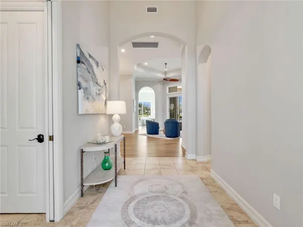 a dining room with furniture potted plants and wooden floor