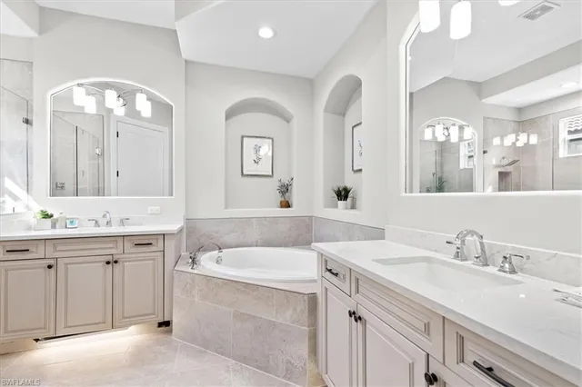 a spacious bathroom with a double vanity sink mirror and