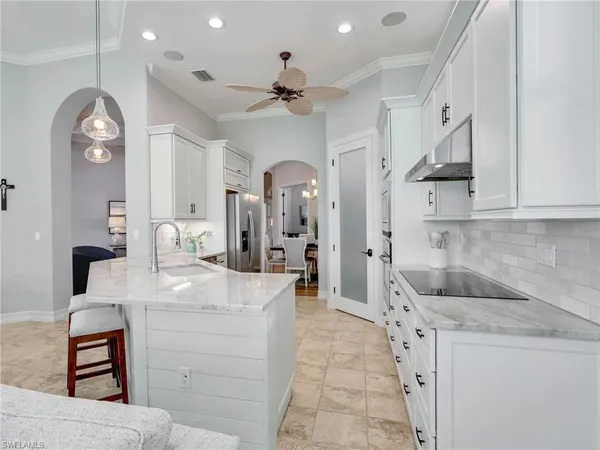 a living room with furniture a ceiling fan and a window