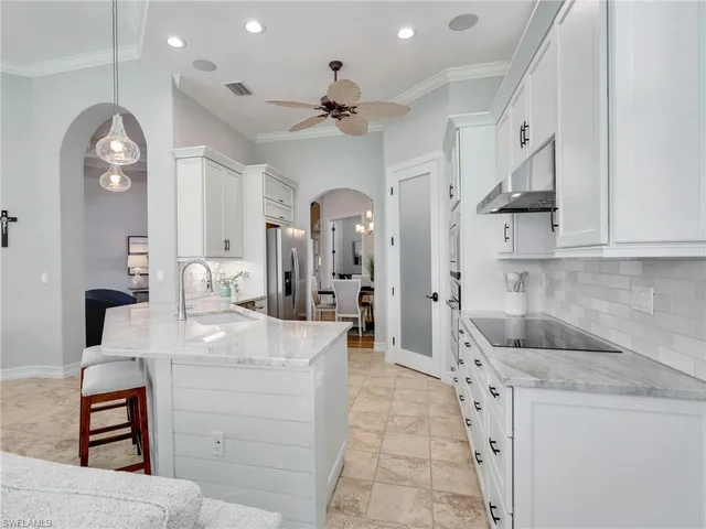 a living room with furniture a ceiling fan and a window