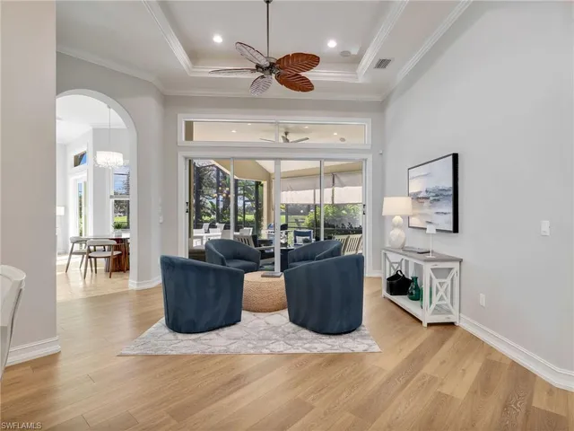 a view of a dining room with furniture a chandelier and wooden floor