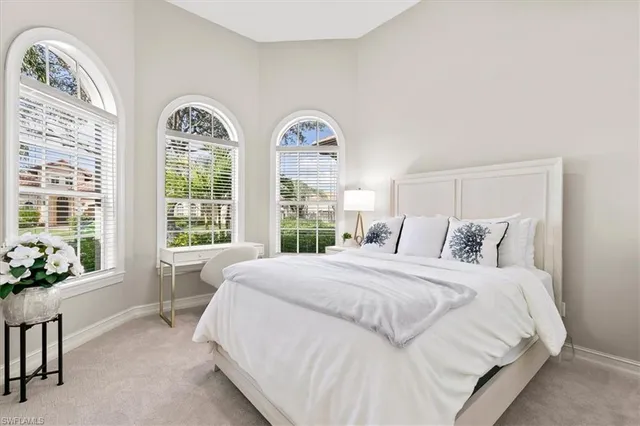 a bedroom with a bed and a large window