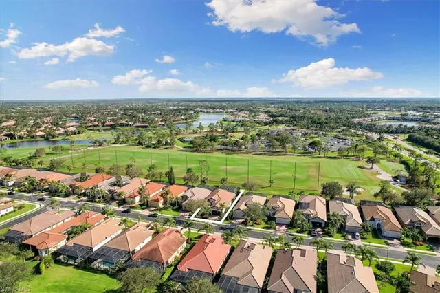 an aerial view of a house with a big yard