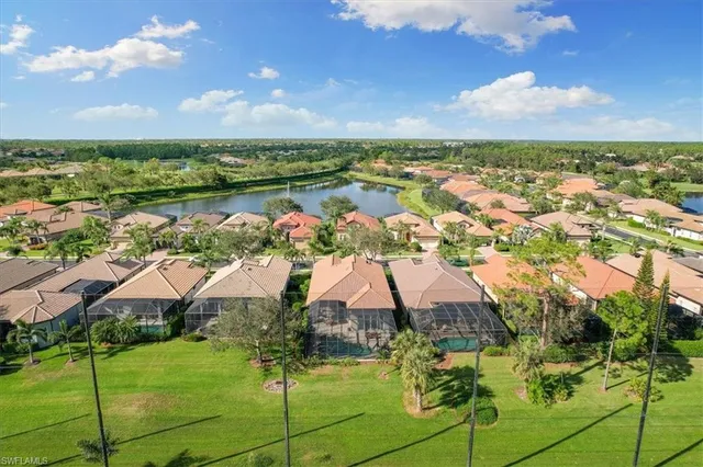 an aerial view of residential houses with outdoor space and trees