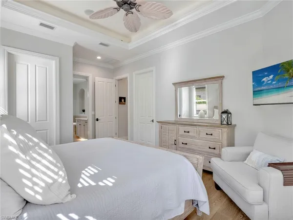 a spacious bathroom with a granite countertop sink a large mirror and a bathtub