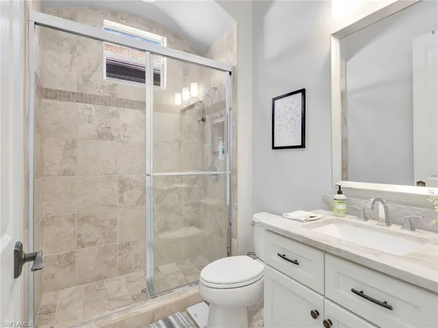 a spacious bedroom with a bed and a couch