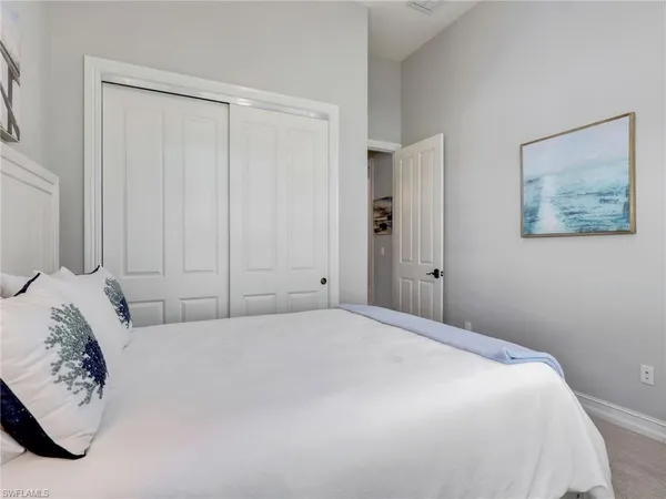 a bedroom with furniture and a lamp