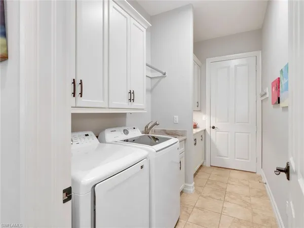 an aerial view of a house with a garden and lake view