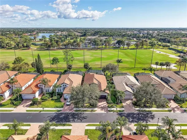 an aerial view of a house with a big yard