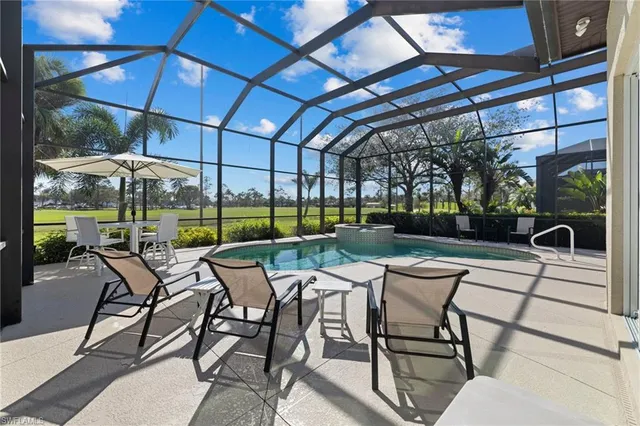 a view of a patio with a table and chairs under an umbrella