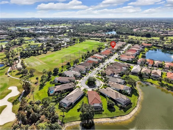 an aerial view of residential houses with outdoor space and swimming pool