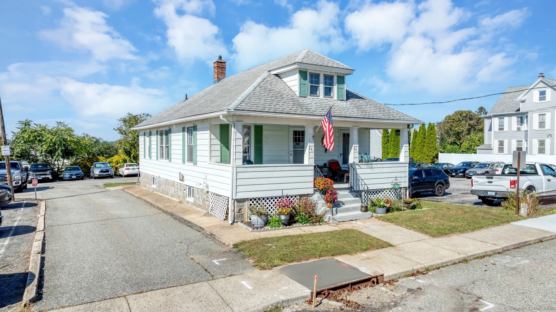 a front view of a house with garden and plants