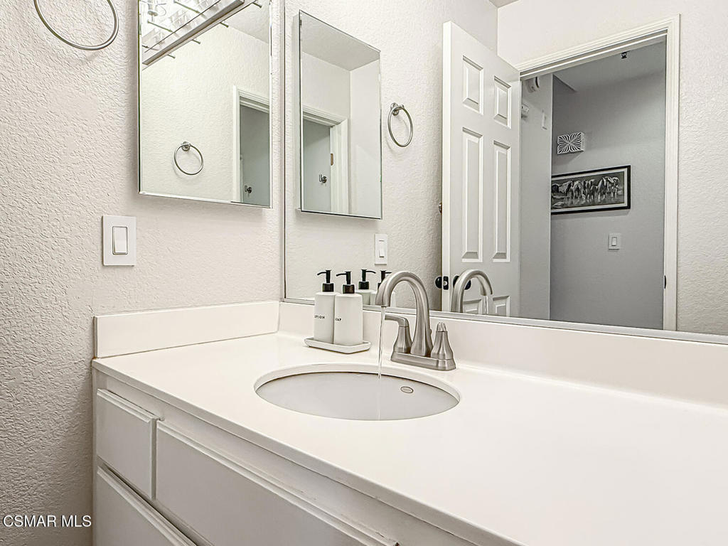 5837 Oak Bend Lane, Unit 302 Oak Park, CA 91377 - Photo 16 of 59 a bathroom with a sink and a mirror