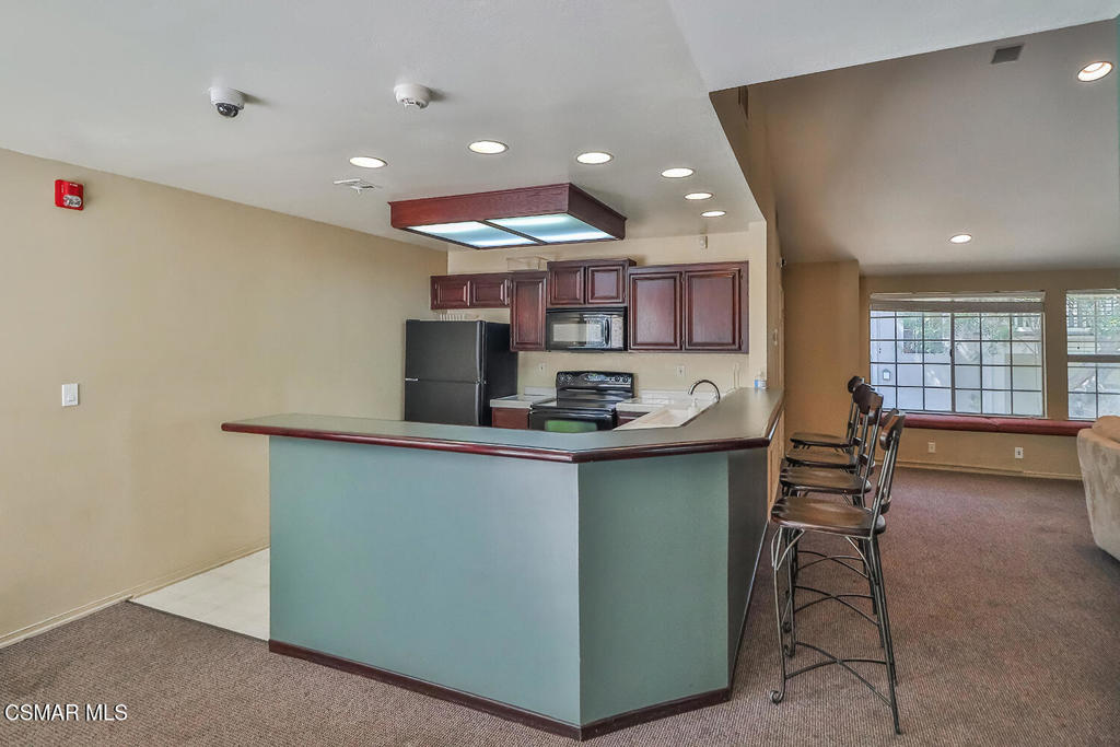 5837 Oak Bend Lane, Unit 302 Oak Park, CA 91377 - Photo 31 of 59 a kitchen with a sink cabinets and wooden floor