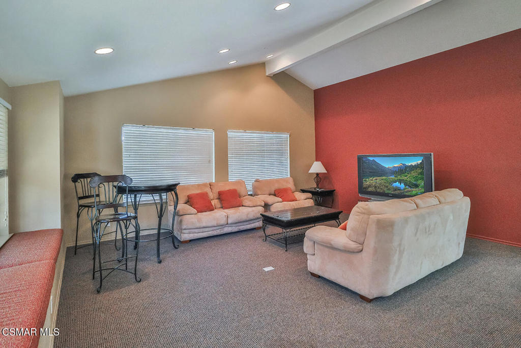 5837 Oak Bend Lane, Unit 302 Oak Park, CA 91377 - Photo 33 of 59 a living room with furniture and a fireplace