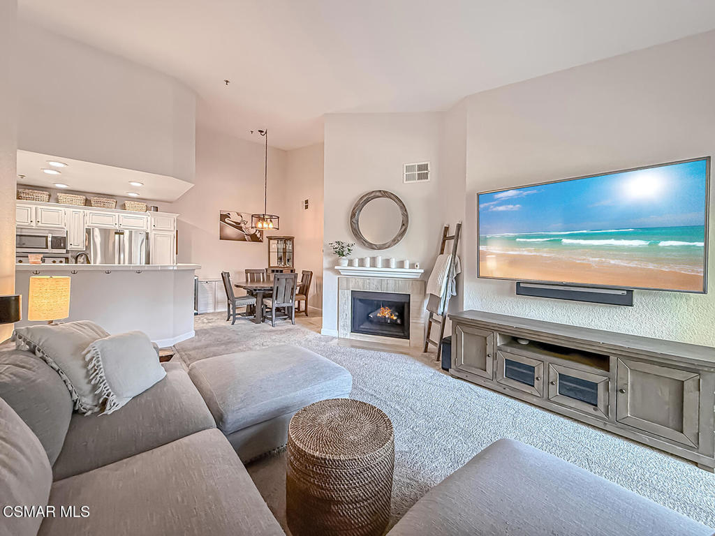 5837 Oak Bend Lane, Unit 302 Oak Park, CA 91377 - Photo 7 of 59 a living room with furniture a fireplace and a flat screen tv