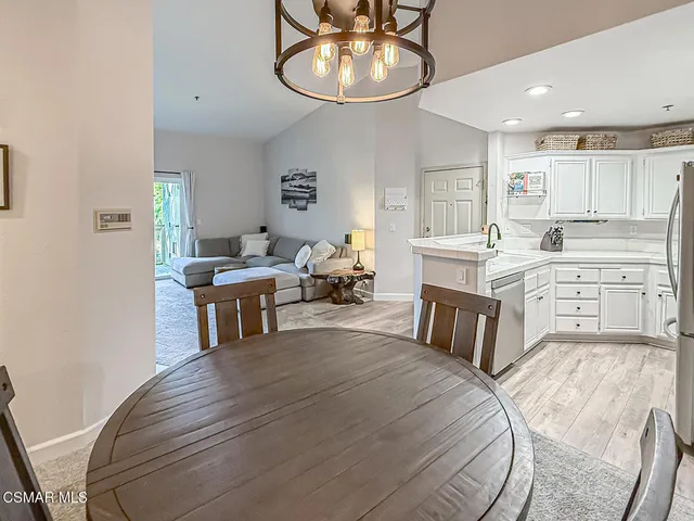 a large white kitchen with sink and cabinets