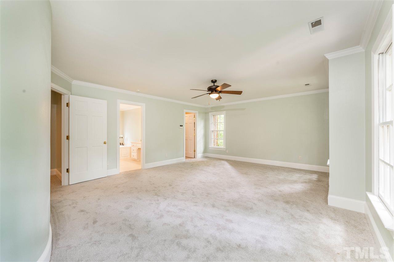 2105 Inverrary Court Raleigh, NC 27615 - Photo 15 of 29 a view of an empty room with a ceiling fan