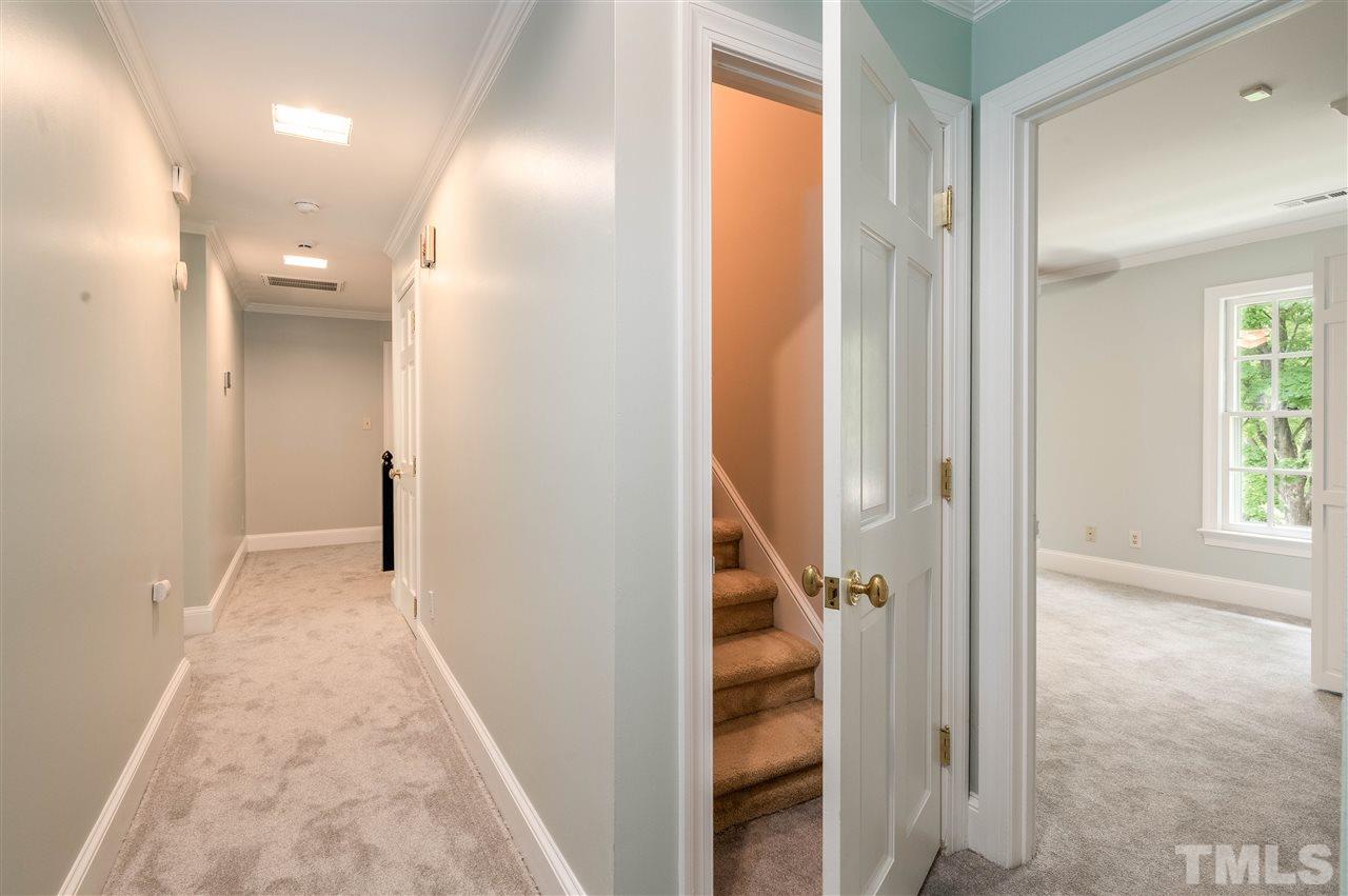 2105 Inverrary Court Raleigh, NC 27615 - Photo 20 of 29 a view of a hallway with wooden floor and staircase