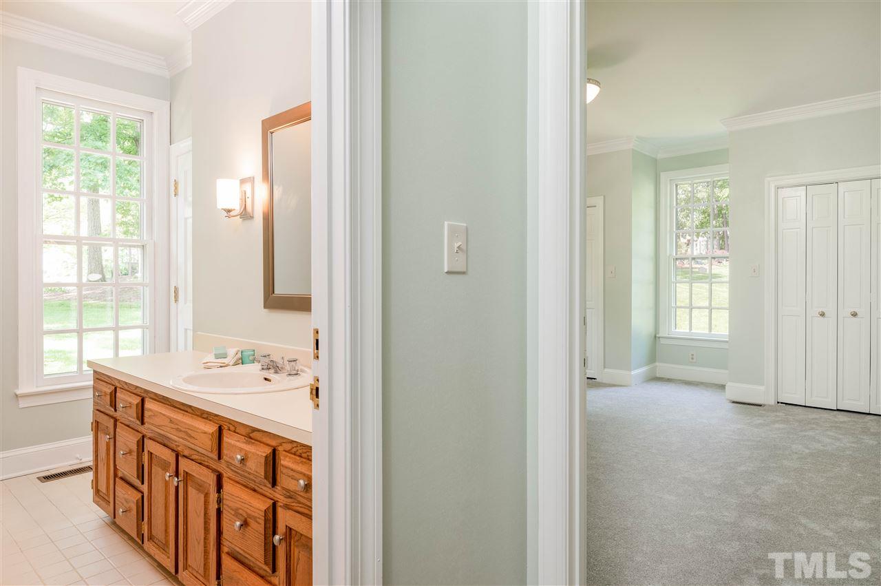 2105 Inverrary Court Raleigh, NC 27615 - Photo 9 of 29 a bathroom with a sink mirror and a bathtub