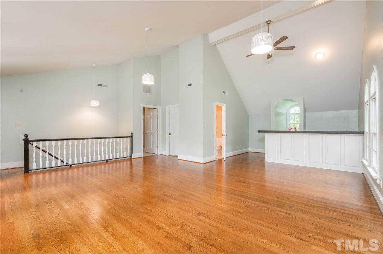 2105 Inverrary Court Raleigh, NC 27615 - Photo 10 of 29 a view of an empty room with wooden floor