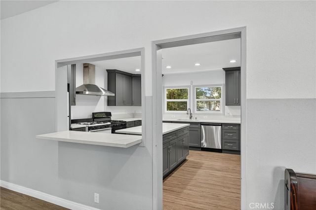 a kitchen with a stove a sink and a refrigerator
