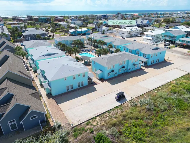 an aerial view of residential houses with outdoor space