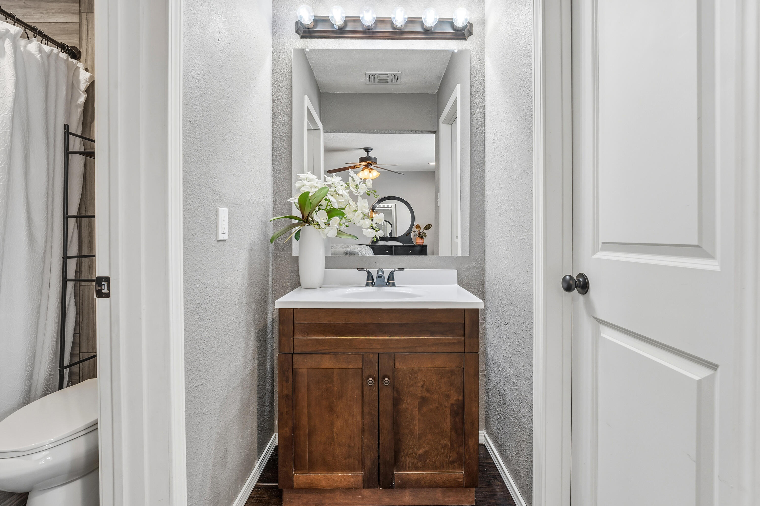 5736 2nd Place Lubbock, TX 79416 - Photo 18 of 26 a bathroom with a sink a toilet and shower