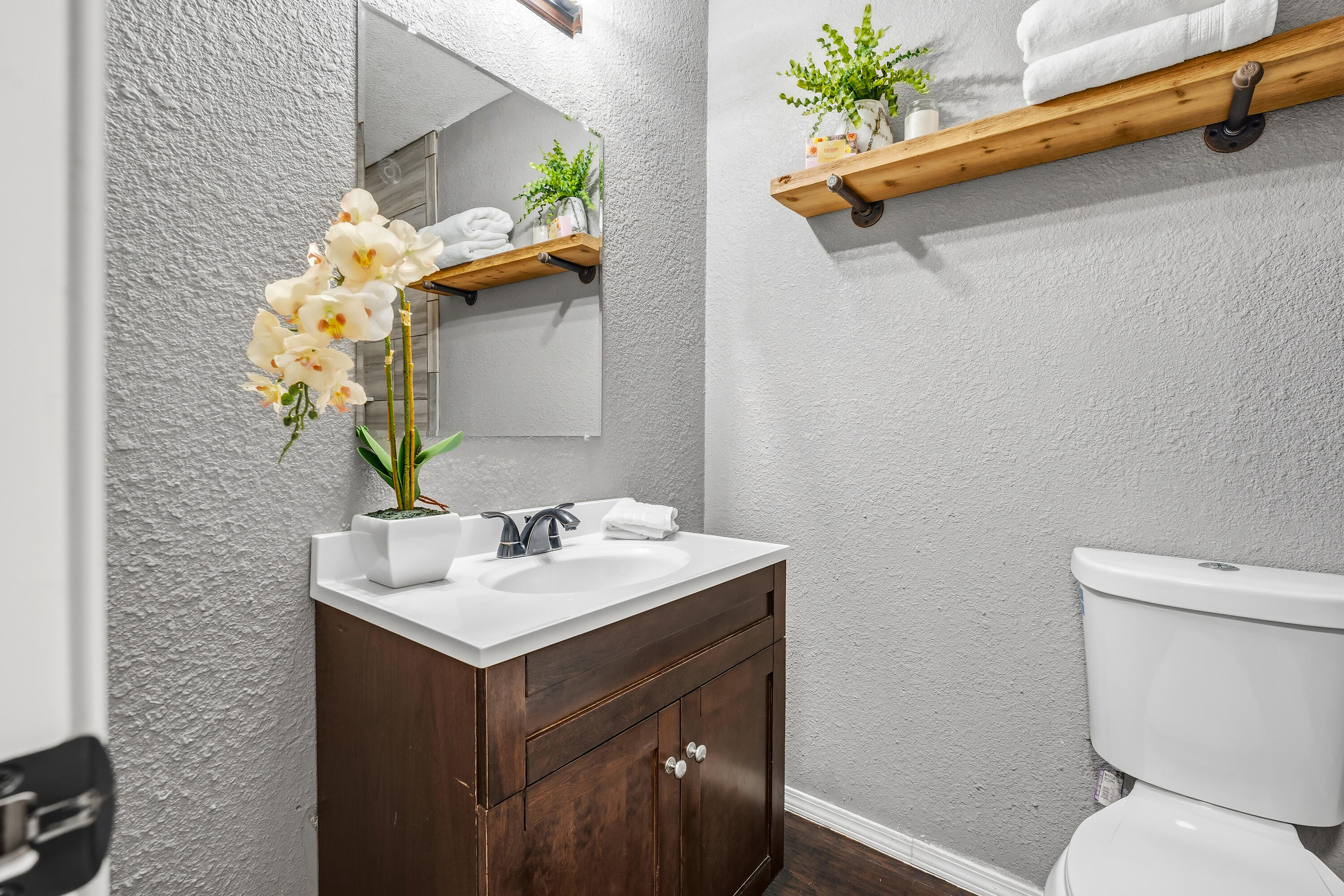 5736 2nd Place Lubbock, TX 79416 - Photo 21 of 26 a bathroom with a sink toilet and a mirror