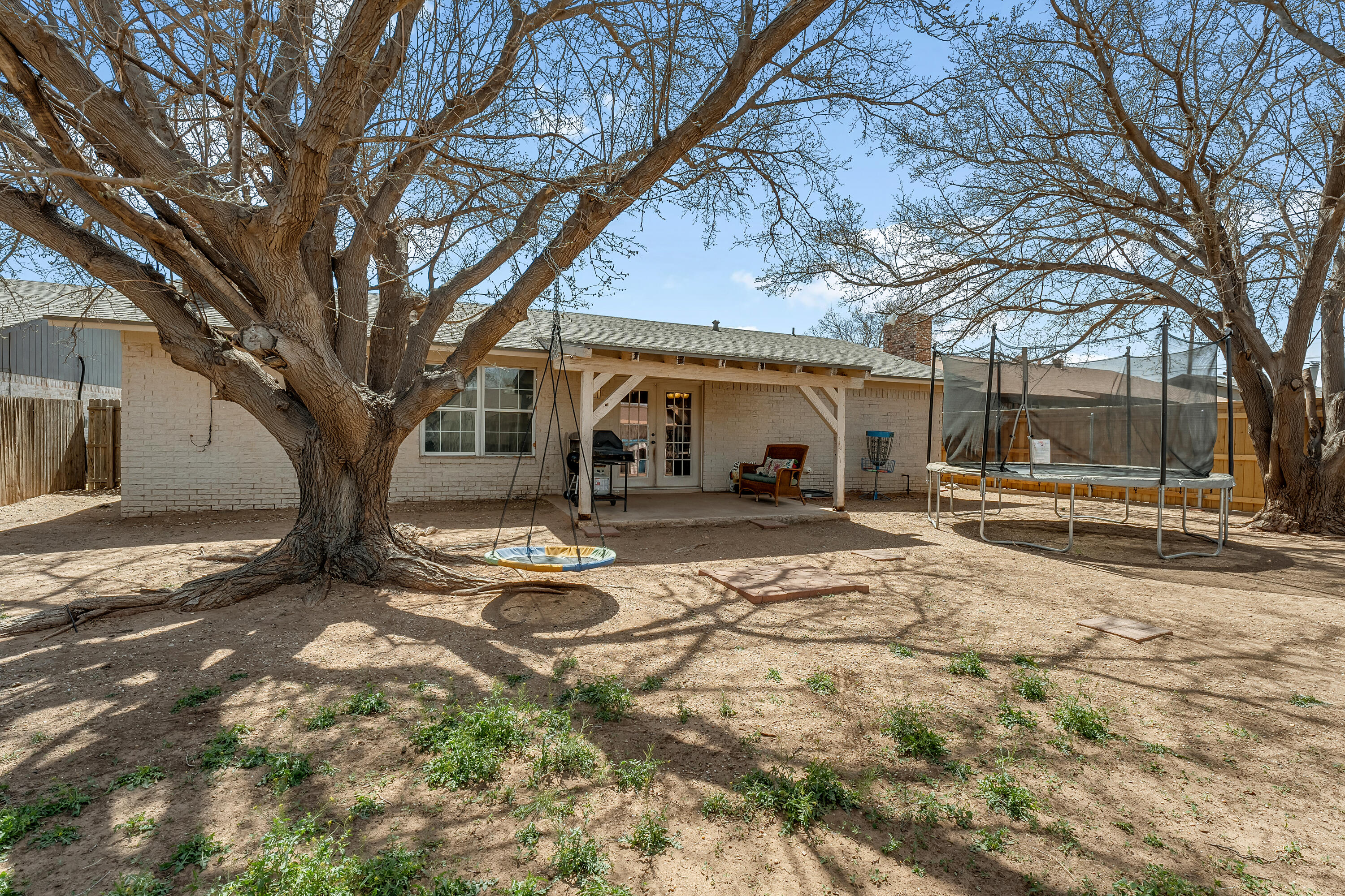 5736 2nd Place Lubbock, TX 79416 - Photo 26 of 26 a view of a large white house with a large tree