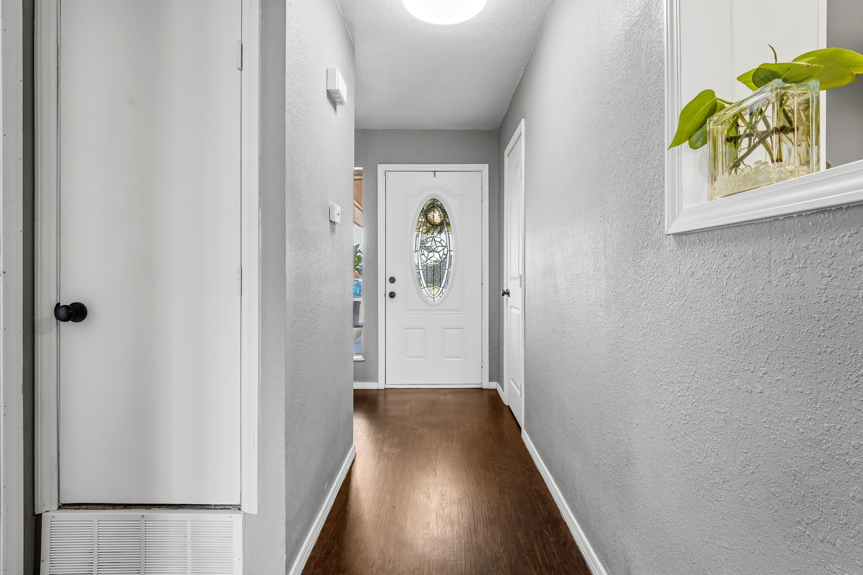 5736 2nd Place Lubbock, TX 79416 - Photo 4 of 26 a view of a hallway with entryway to a bedroom