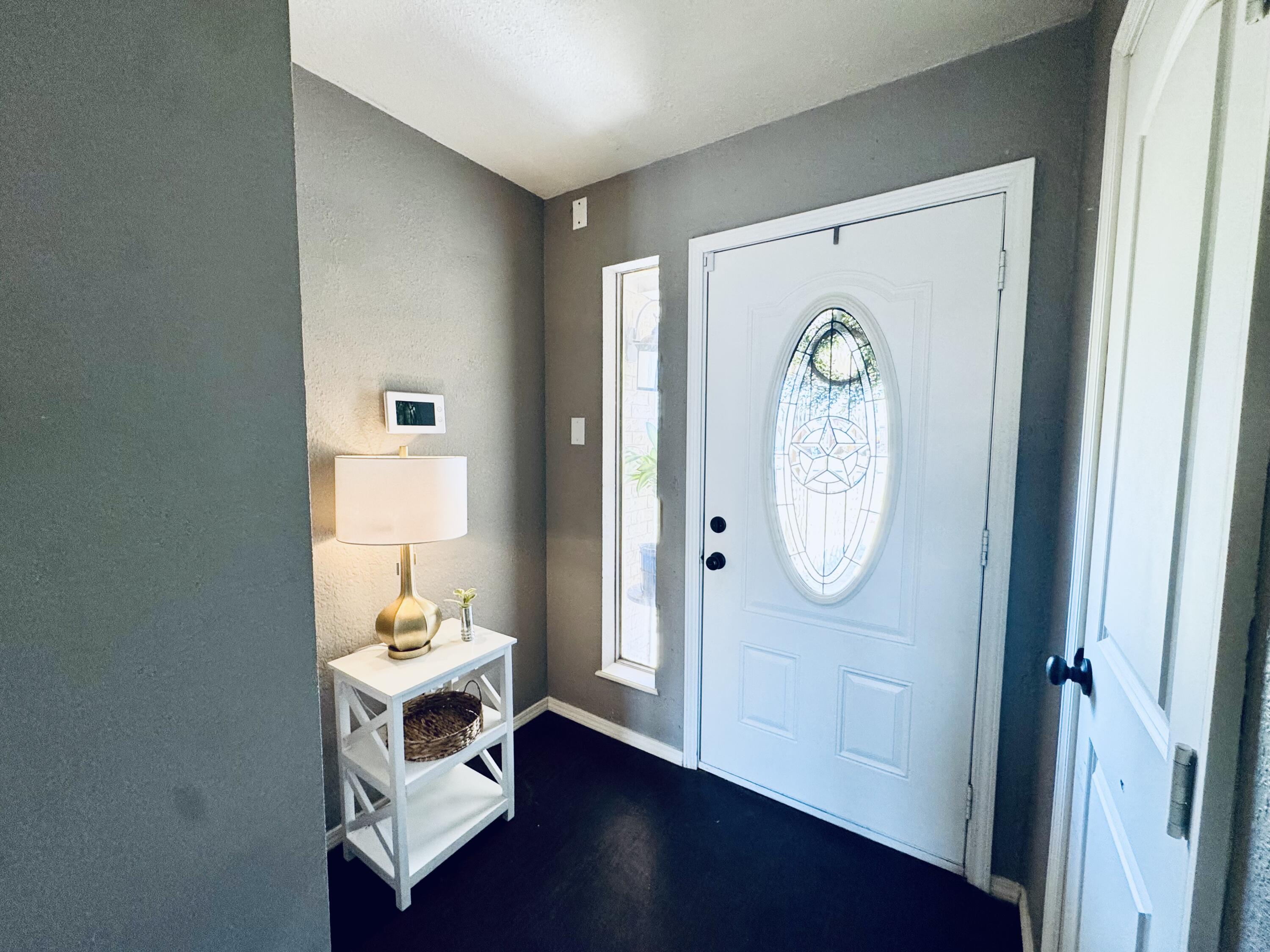 5736 2nd Place Lubbock, TX 79416 - Photo 5 of 26 a room with wooden floor and a window