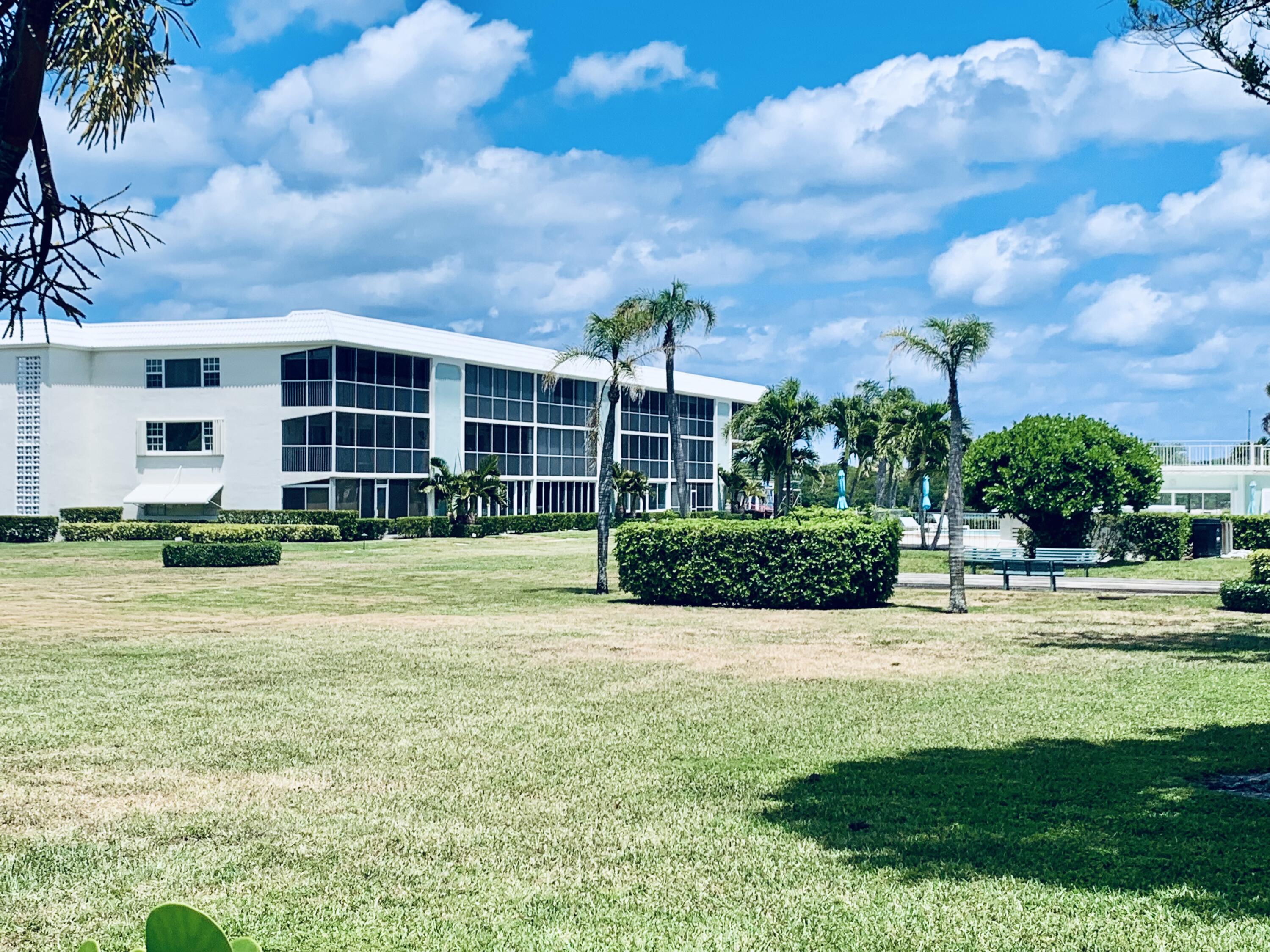 100 Waterway Road, Unit A304 Tequesta, FL 33469 - Photo 1 of 90 a view of a house with a big yard and large trees