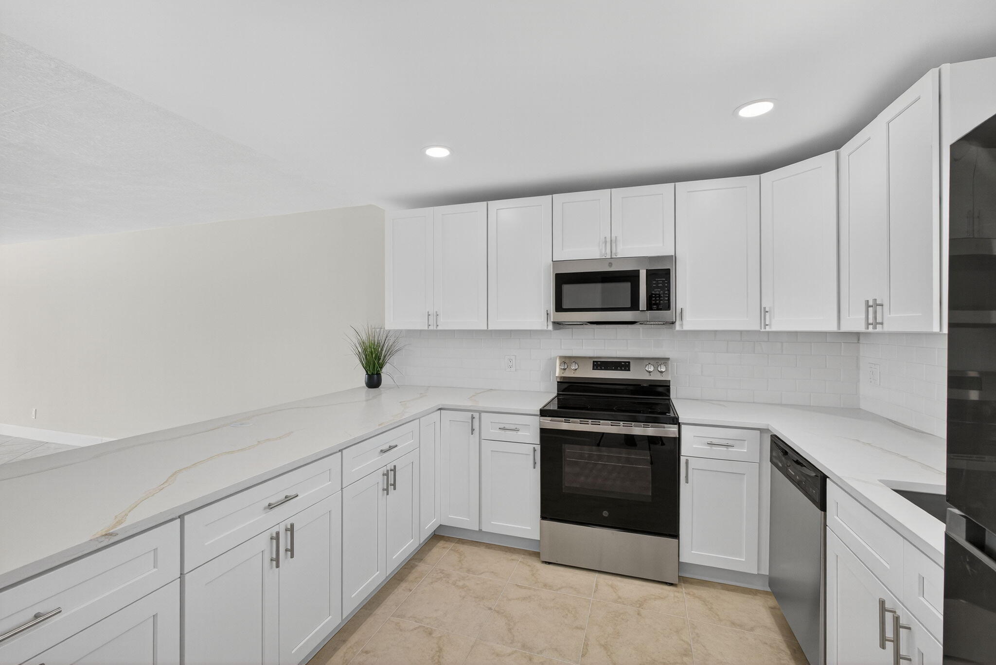 100 Waterway Road, Unit A304 Tequesta, FL 33469 - Photo 17 of 90 a kitchen with white cabinets and stainless steel appliances