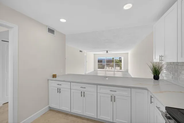 a bathroom with a bathtub shower sink mirror vanity and toilet