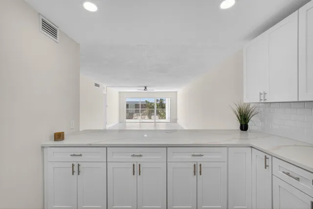 a bathroom with a glass door shower and mirror