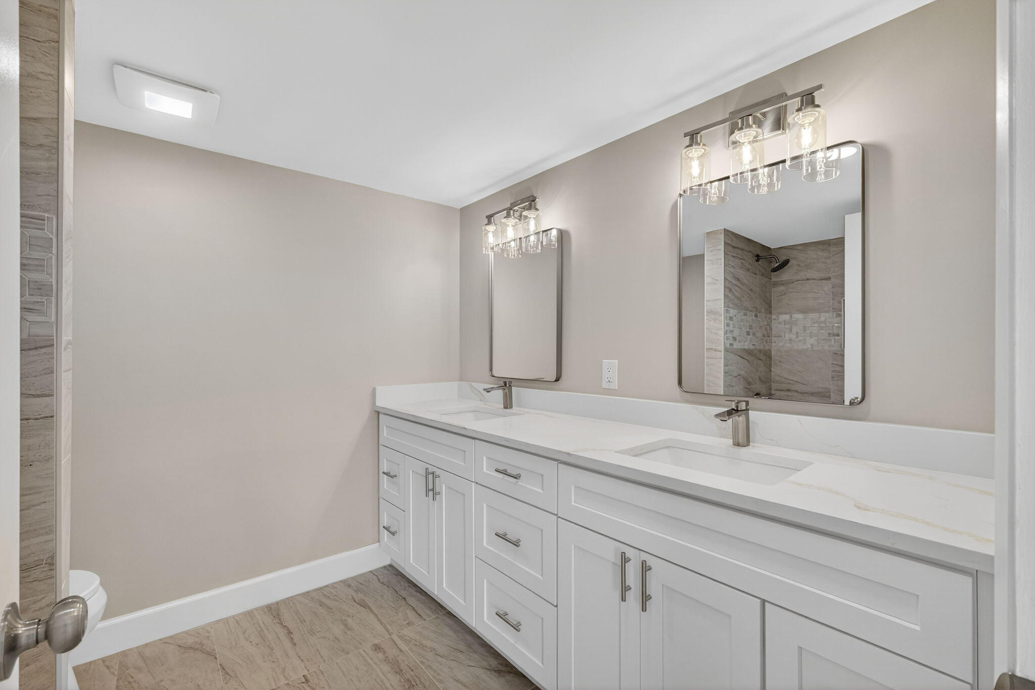 100 Waterway Road, Unit A304 Tequesta, FL 33469 - Photo 28 of 90 a bathroom with a double vanity sink and mirror