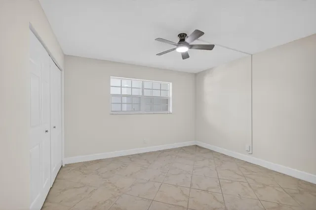 a view of a swimming pool and lounge chairs in back yard of the house