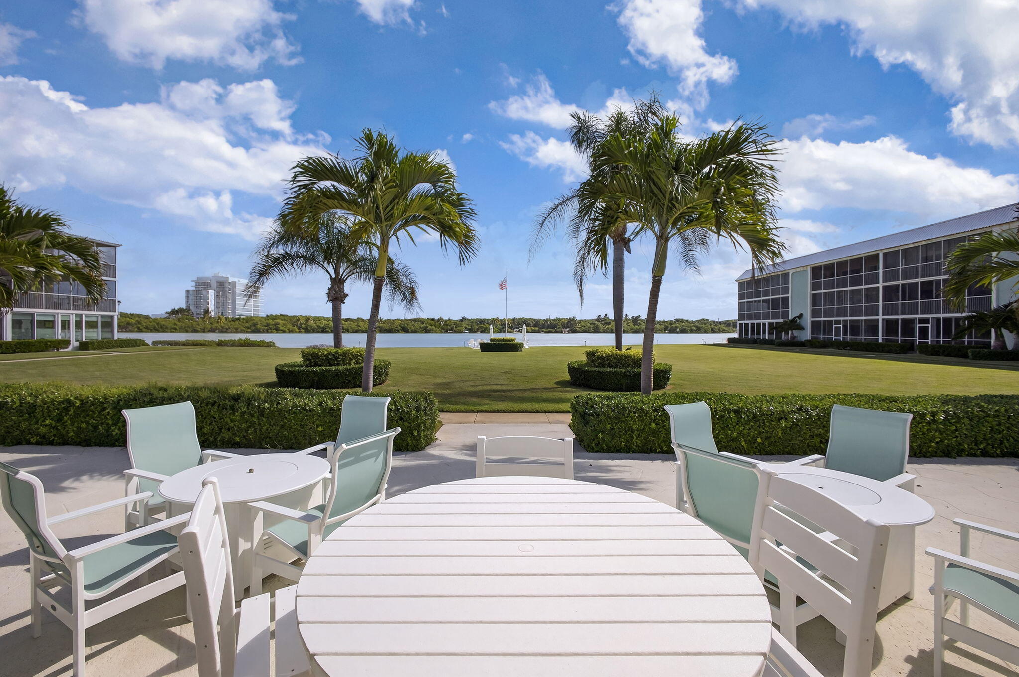 100 Waterway Road, Unit A304 Tequesta, FL 33469 - Photo 55 of 90 a view of a swimming pool and lounge chairs in back yard of the house