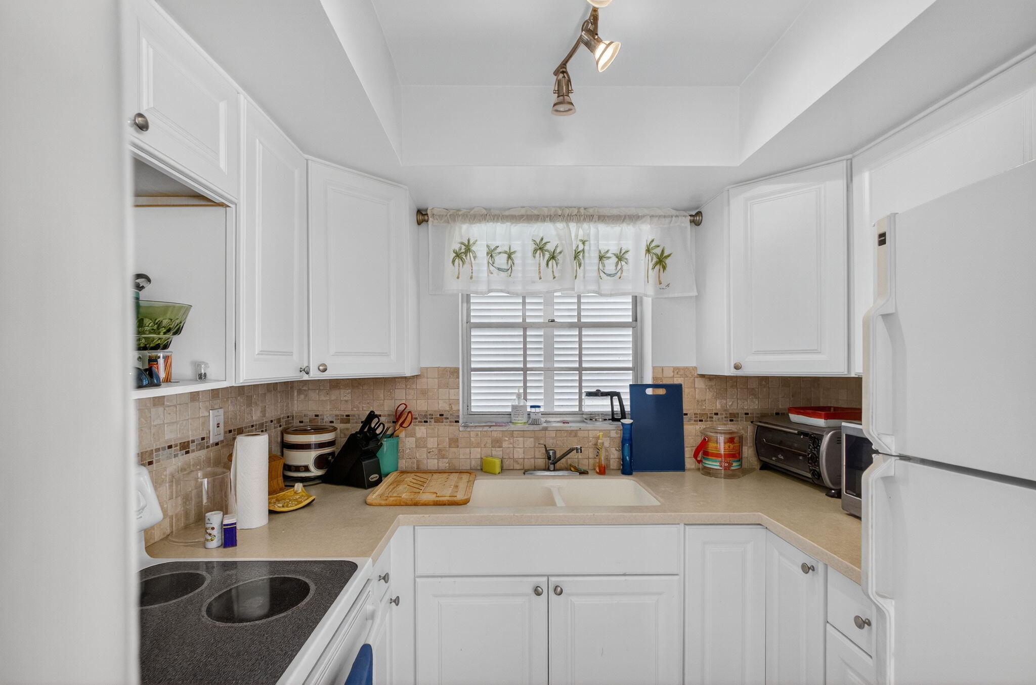 100 Waterway Road, Unit A304 Tequesta, FL 33469 - Photo 58 of 90 a kitchen with a sink a stove and cabinets