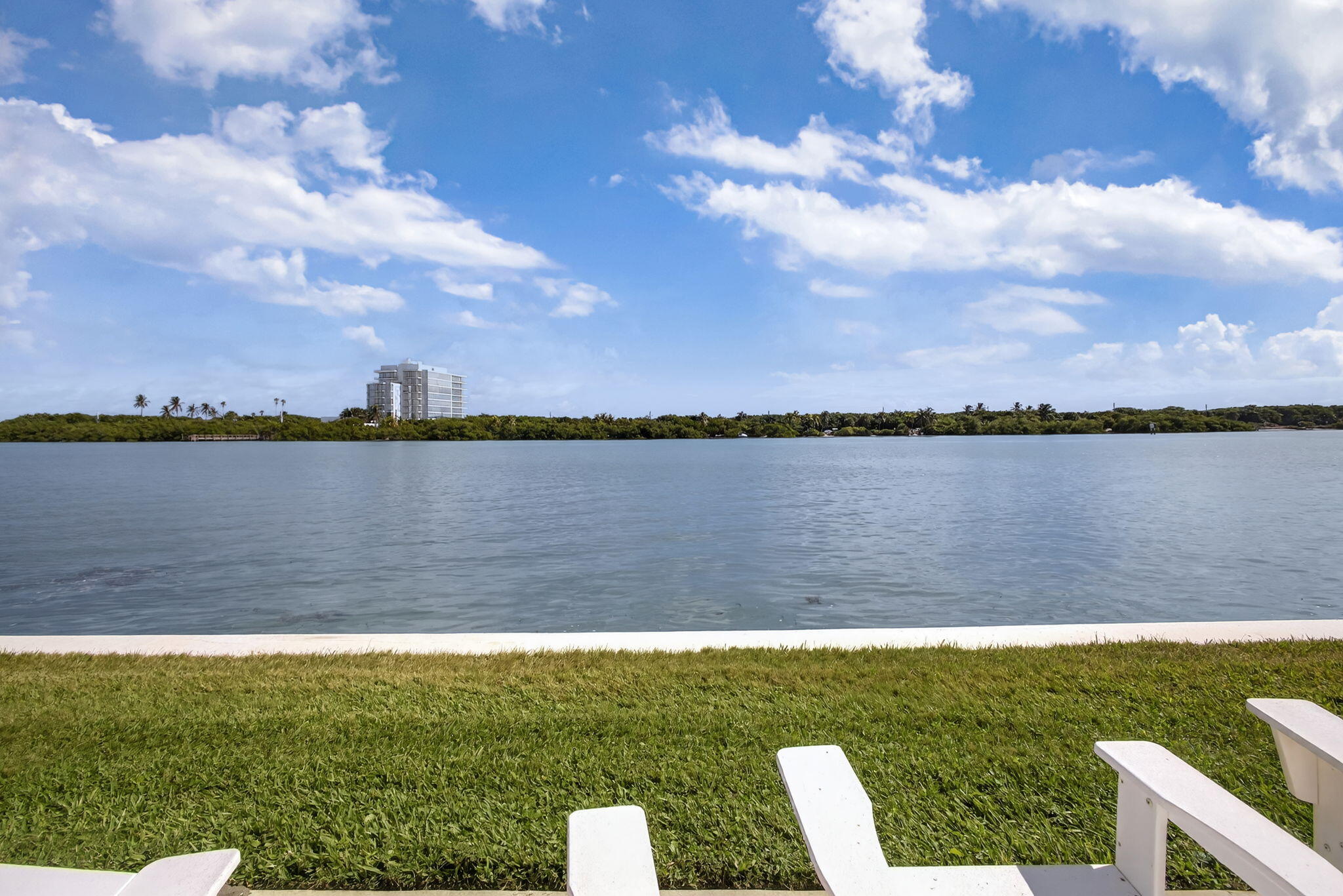 100 Waterway Road, Unit A304 Tequesta, FL 33469 - Photo 66 of 90 a view of a lake with houses in the back