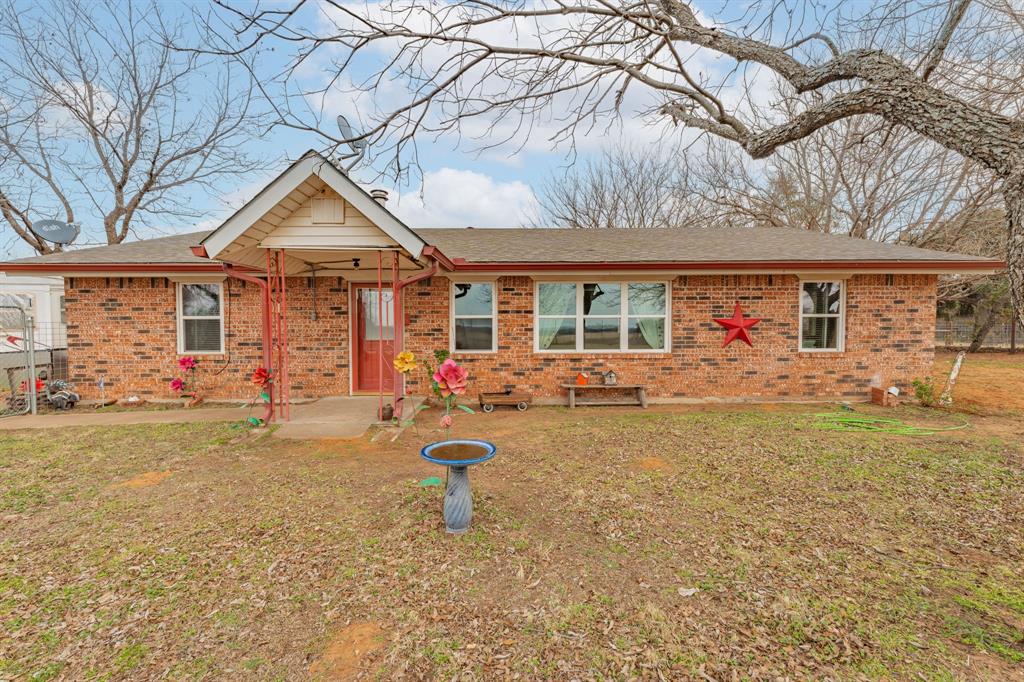 941 Farm To Market 1287 Graham, TX 76450 - Photo 1 of 39 a front view of a house with garden