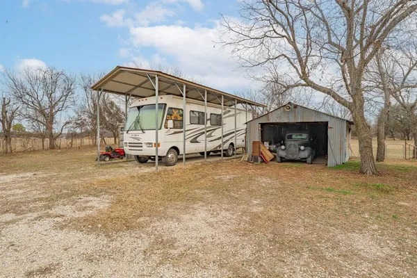 a view of a house with backyard porch and sitting area