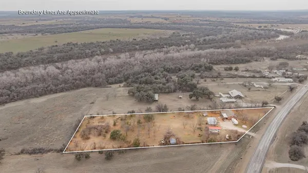 a view of dirt field with trees