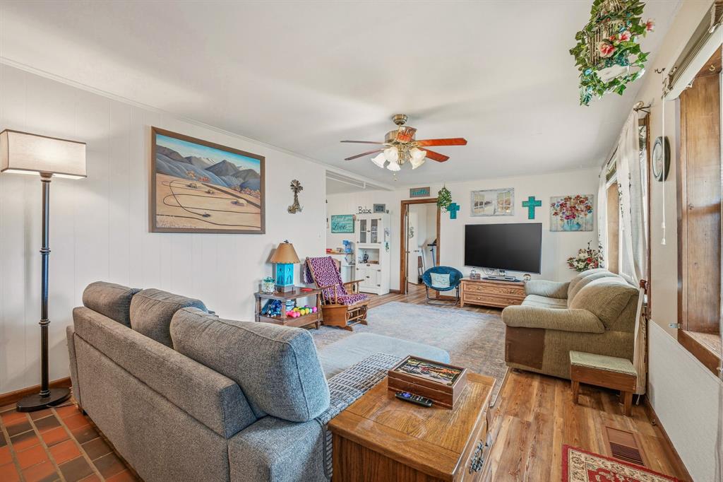 941 Farm To Market 1287 Graham, TX 76450 - Photo 7 of 39 a living room with furniture a flat screen tv and a potted plant