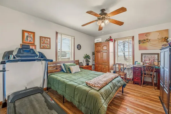 a bedroom with a bed and a chandelier