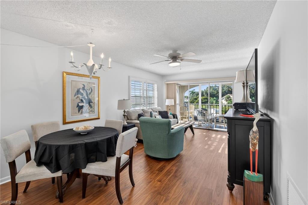 5 High Point Circle West, Unit 303 Naples, FL 34103 - Photo 12 of 36 a living room with furniture and wooden floor