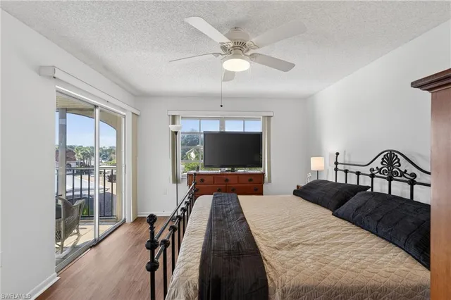 a bedroom with bed and flat screen tv